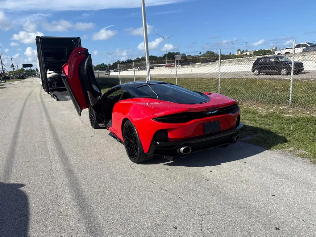 Red McLaren Supercar unloaded from enclosed trailer